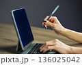 Woman using stylus pen with digital tablet computer closeup 136025042