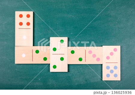 Wooden Domino Tiles Arranged In Cross Pattern On Green Background Wooden Domino Tiles Arranged In Cross Pattern On Green Background 136025936