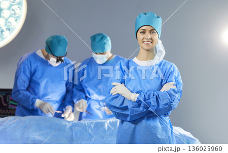 Surgeons operate on patient in surgery to transplant organ and save life in emergency room 136025960