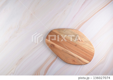 Wooden cutting board on a gray marble background Wooden cutting board on a gray marble background 136027074