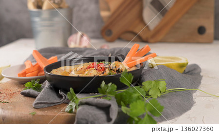 Delicious hummus in ceramic bowl 136027360