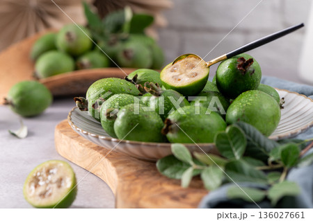 Fresh green feijoa fruit on a white plate Fresh green feijoa fruit on a white plate 136027661