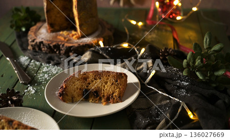 Cozy Christmas Panettone Slice on a Green Table 136027669