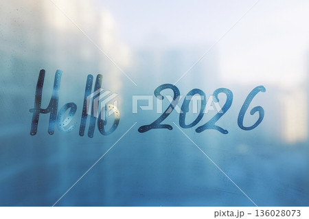 Handwritten lettering Hello and arabic numerals 2026 on misted glass on blue sunset window Handwritten lettering Hello and arabic numerals 2026 on misted glass on blue sunset window 136028073