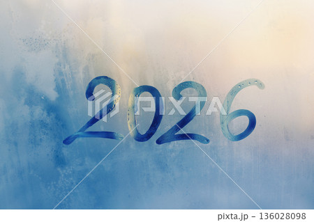 Handwritten arabic numerals 2026 on misted glass on sunrise blue window flooded with raindrops Handwritten arabic numerals 2026 on misted glass on sunrise blue window flooded with raindrops 136028098