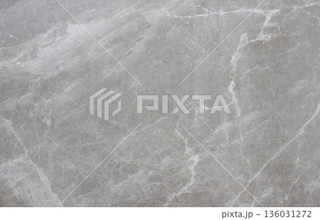 Tundra Grey marble texture with smooth surface and soft white vein patterns spreading across the natural stone surface. 136031272