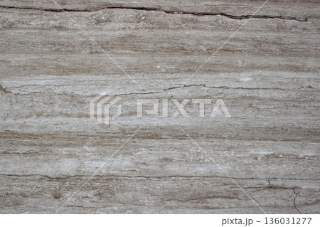Cross section of Silver Travertine stone showing contrasting layers of grey and brown sedimentary colors. Cross section of Silver Travertine stone showing contrasting layers of grey and brown sedimentary colors. 136031277