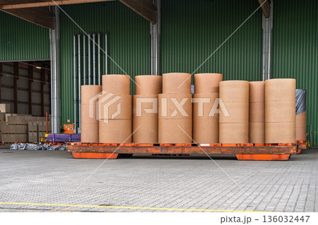 Paper Rolls on a Flatbed Trailer in a Warehouse, Ready for Transportation and Distribution Paper Rolls on a Flatbed Trailer in a Warehouse, Ready for Transportation and Distribution 136032447