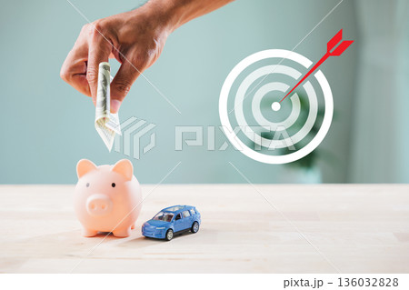 economy money finance global growth market piggy bank financial invest strategy shows hand putting dollar bill inside coin slot near blue toy car under target icon with red arrow economy money finance global growth market piggy bank financial invest strategy shows hand putting dollar bill inside coin slot near blue toy car under target icon with red arrow 136032828