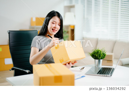 Small business entrepreneur SME freelance woman working at home office, BOX,tablet and laptop online, marketing, packaging, delivery,  e-commerce concept 136034292