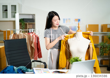 Fashion designer presenting apparel on mannequin with color palette in a studio. Creative styling process, garment development, textile planning Fashion designer presenting apparel on mannequin with color palette in a studio. Creative styling process, garment development, textile planning 136034386