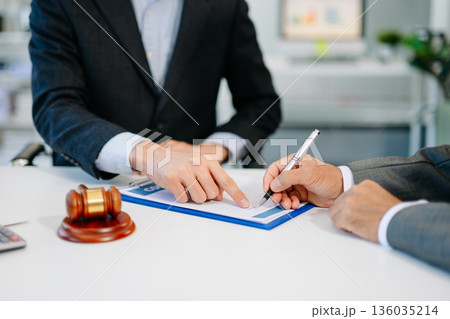 business people and lawyers discussing contract papers sitting at the table. Concepts of law, advice, legal services. business people and lawyers discussing contract papers sitting at the table. Concepts of law, advice, legal services. 136035214