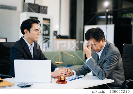 Lawyer comforting upset client during business meeting, symbolizing empathy, legal support, and emotional guidance Lawyer comforting upset client during business meeting, symbolizing empathy, legal support, and emotional guidance 136035250