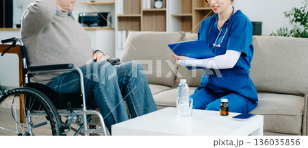 Nurse in blue scrubs reviews medication with an elderly patient at home, showcasing real people, compassionate care Nurse in blue scrubs reviews medication with an elderly patient at home, showcasing real people, compassionate care 136035856