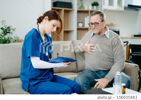 Senior man consulting nurse at home, discussing health and recovery with care, compassion, and trust. Healthcare and support service Senior man consulting nurse at home, discussing health and recovery with care, compassion, and trust. Healthcare and support service 136035881
