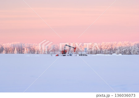 Snow Covered Oil Pumpjack at Winter Sunrise Snow Covered Oil Pumpjack at Winter Sunrise 136036073