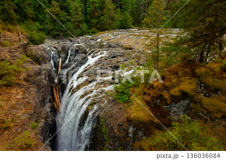 Streams of the rocky waterfall in the river canyon in the forest. Streams of the rocky waterfall in the river canyon in the forest. 136036084