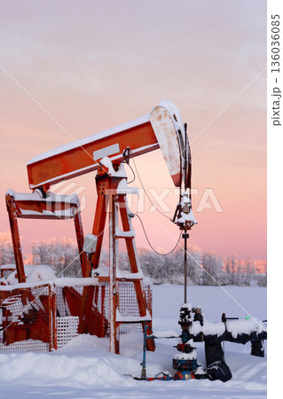 Snow Covered Oil Pumpjack at Winter Sunrise Snow Covered Oil Pumpjack at Winter Sunrise 136036085