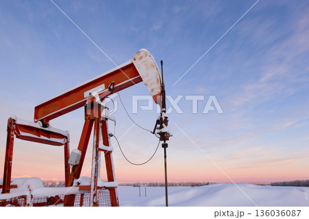 Snow Covered Oil Pumpjack at Winter Sunrise Snow Covered Oil Pumpjack at Winter Sunrise 136036087