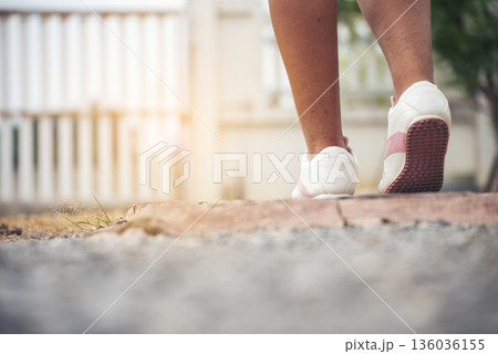 Sport sneakers footwear young woman knelt down do up shoelaces. Ready running shoes in sport exercise jogging person. Close up hands tie up runner shoelaces in fitness gym healthy person lifestyle. Sport sneakers footwear young woman knelt down do up shoelaces. Ready running shoes in sport exercise jogging person. Close up hands tie up runner shoelaces in fitness gym healthy person lifestyle. 136036155