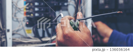 Banner Electrical mechanic technician check wire electric cabinet. Inspector men hands working maintenance service. Electrician circuit repair operation. Men hands fix breaker with copy space 136036164