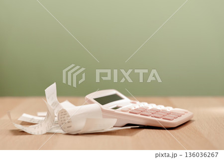Calculator and bills on table. Calculating expenses, paying bills, personal finance Calculator and bills on table. Calculating expenses, paying bills, personal finance 136036267