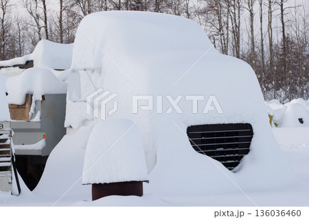 Old abandoned dump truck covered with high snow. 136036460