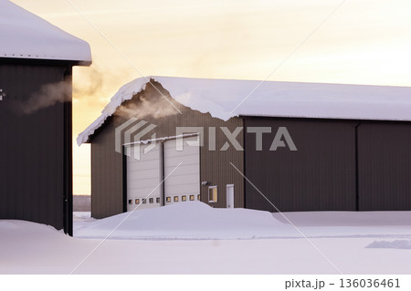 Steam from heater in industrial building in sunset time in winter. 136036461