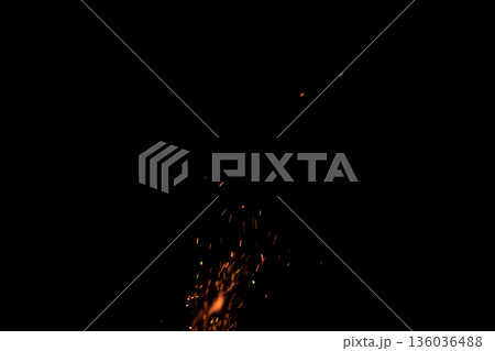 Sparks from campfire over dark background in the night Sparks from campfire over dark background in the night 136036488