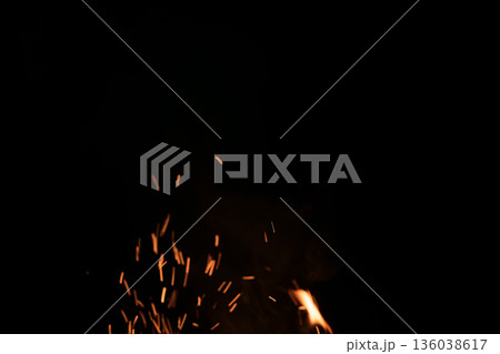 Sparks from campfire over dark background in the night Sparks from campfire over dark background in the night 136038617