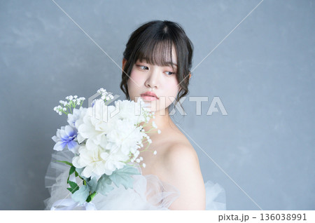 グレー背景でウェディングドレスを着る女性 グレー背景でウェディングドレスを着る女性 136038991