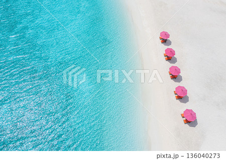 Stunning turquoise ocean aerial umbrellas tropical beach. Tranquil summer vacation nature background 136040273