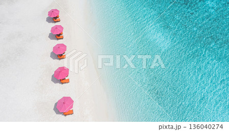 Colorful umbrellas on white sand beach aerial view. Artistic summer holiday resort wallpaper design Colorful umbrellas on white sand beach aerial view. Artistic summer holiday resort wallpaper design 136040274