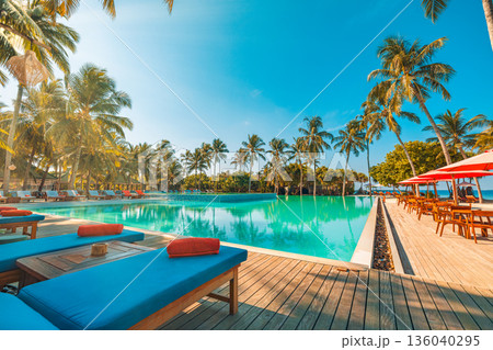 Panoramic sunset luxury beach resort infinity pool palm trees sun loungers turquoise water happy summer relaxation paradise 136040295