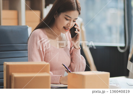 Starting small businesses SME owners female entrepreneurs check online orders to prepare to pack the boxes, sell to customers, sme business ideas online. 136040819