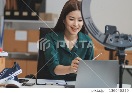 Starting small businesses SME owners female entrepreneurs check online orders to prepare to pack the boxes, sell to customers, sme business ideas online. 136040839