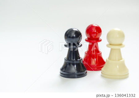 Standing red pawn holding position under pressure representing ethical leadership or diversity. Customizable space for text. 136041332