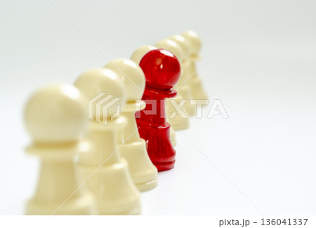 Standing red pawn breaking formation representing speaking up. Standing red pawn breaking formation representing speaking up. 136041337