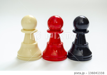 Standing white, red and black pawn representing diversity and inclusion. 136041338