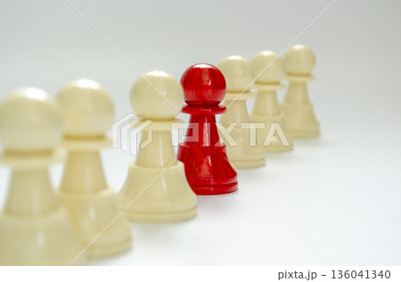 Standing red pawn confronting white pawns representing leadership voice. Standing red pawn confronting white pawns representing leadership voice. 136041340