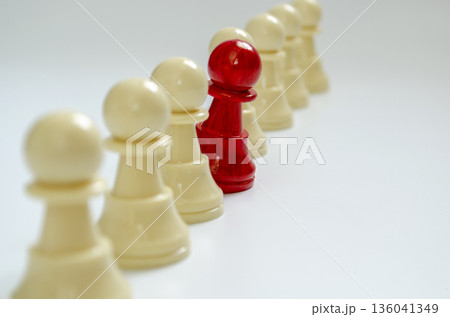 Courage to speak up concept representing by red pawn standing out from the rest of the pawns. 136041349