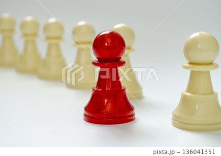 Courage to move forward concept representing by red pawn standing out from the rest of the pawns with customizable space for text. 136041351