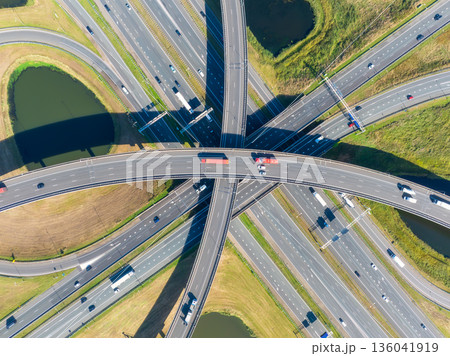 Aerial view of a multilevel highway interchange with busy car traffic. 136041919