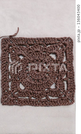 A crochet pattern of brown squares, perfect for home decor and fashion. Pattern. A crochet pattern of brown squares, perfect for home decor and fashion. Pattern. 136043400
