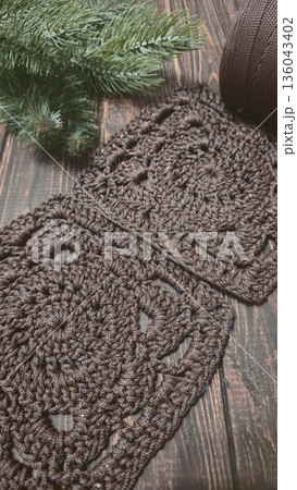 A crochet pattern of brown squares, perfect for home decor and fashion. Pattern. 136043402