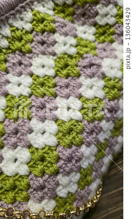 A colorful knitted fabric texture suitable for home decor, fashion, or textile 136043429