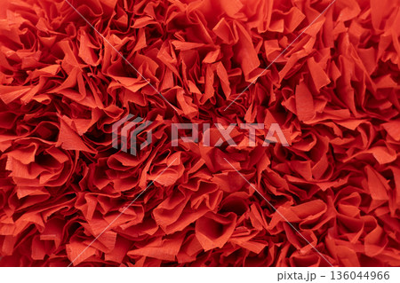 Vibrant red shredded paper texture for crafts, background design, and festive projects 136044966