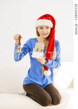 Christmas woman holding calendar and bell 136045226