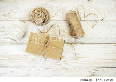 Cardboard boxes and packing twine, delivery concept. Stacking of postal cardboard boxes and packing twine. Cardboard boxes and packing twine, delivery concept. Stacking of postal cardboard boxes and packing twine. 136045656