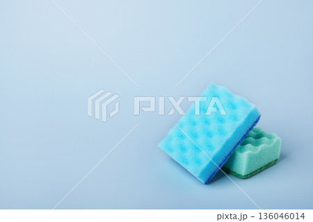 Colorful cleaning sponges on light blue background Colorful cleaning sponges on light blue background 136046014